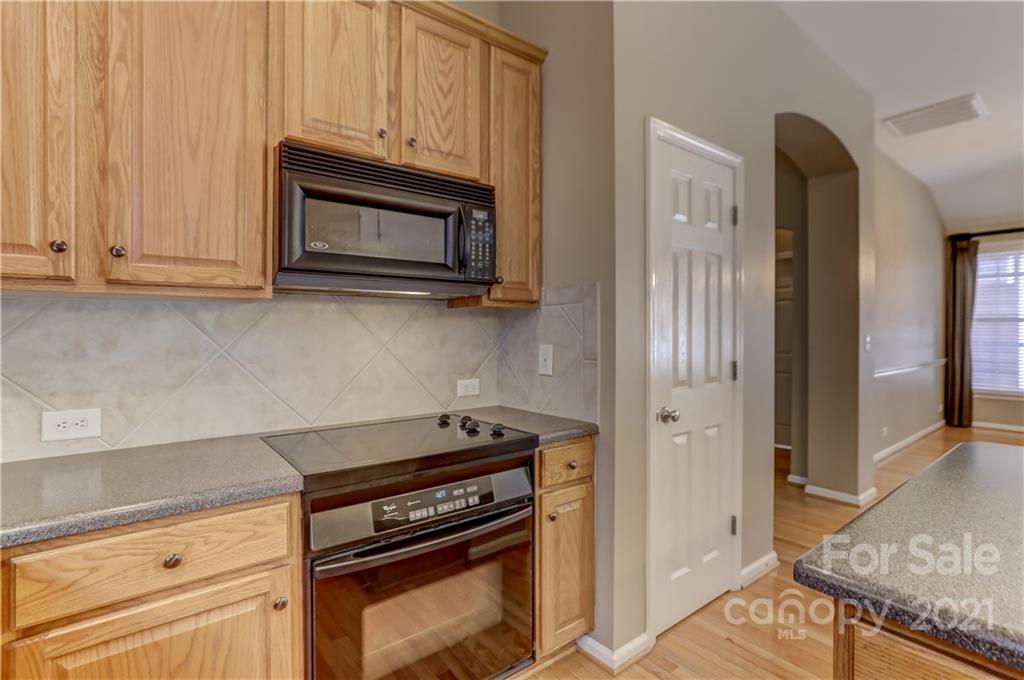 3229 Fifth Baxter Crossing Fort Mill, SC 29708 - Photo 17 of 46 a kitchen with granite countertop cabinets and steel stainless steel appliances