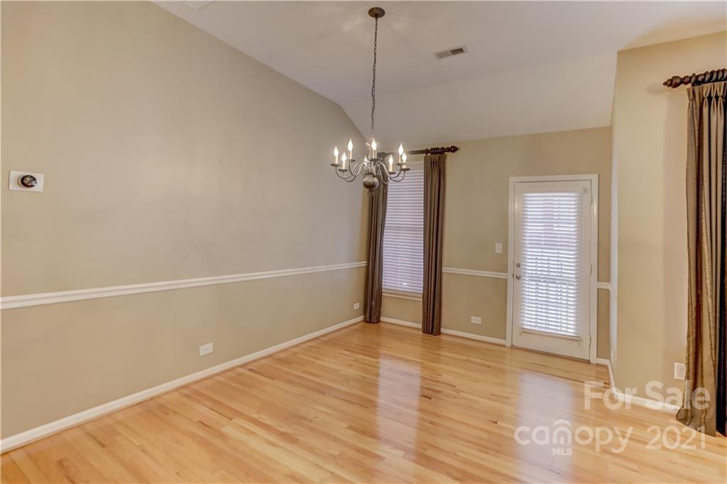3229 Fifth Baxter Crossing Fort Mill, SC 29708 - Photo 23 of 46 a view of a room with wooden floor and chandelier