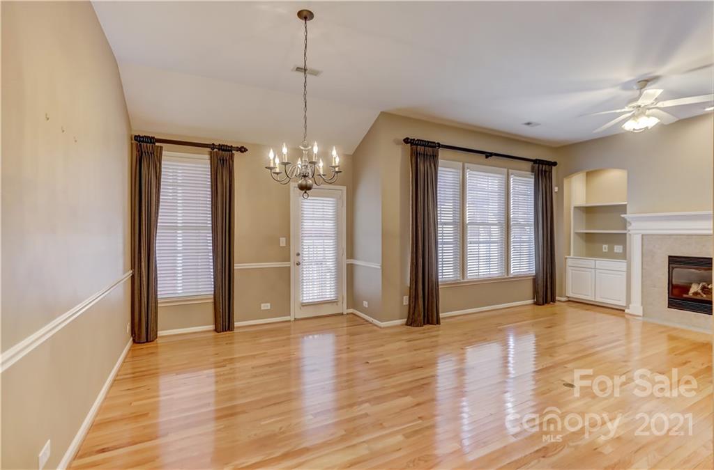 3229 Fifth Baxter Crossing Fort Mill, SC 29708 - Photo 24 of 46 a view of a livingroom with a chandelier fireplace and wooden floor