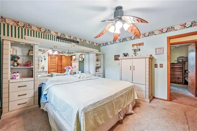 a spacious bedroom with a bed and a mirror