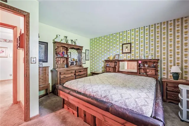 a bedroom with a bed and a dresser in it