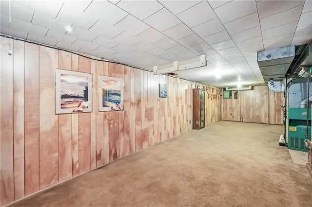 a view of a hallway with wooden walls