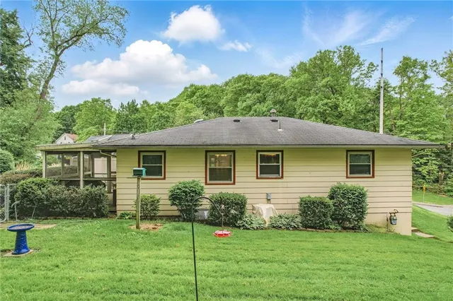 a backyard of a house with table and chairs