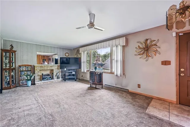 a view of a livingroom with workspace and a window