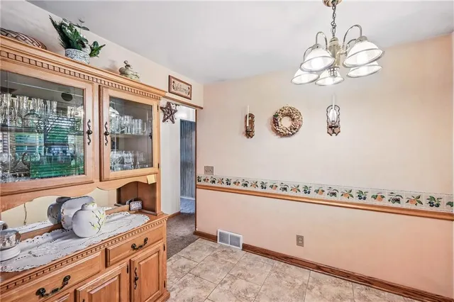 a view of a kitchen island with furniture and chandelier