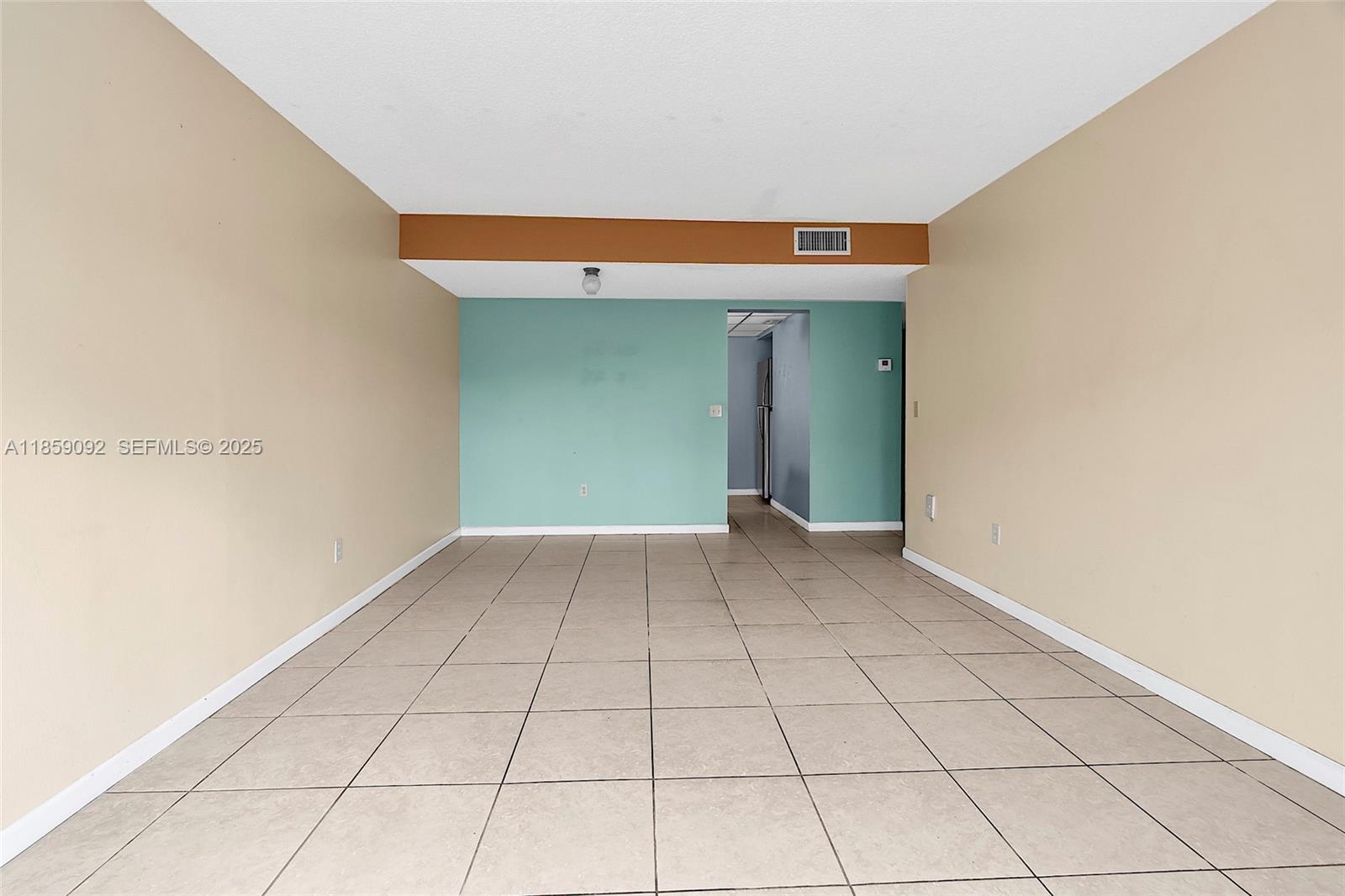 7747 Southwest 86th Street, Unit D106 Miami, FL 33143 - Photo 11 of 19 a view of a livingroom with an empty space and a window