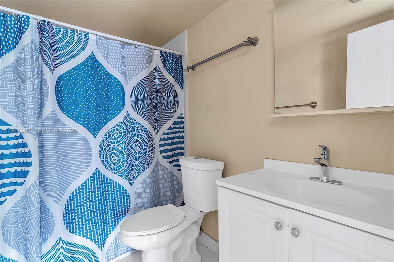 7747 Southwest 86th Street, Unit D106 Miami, FL 33143 - Photo 13 of 19 a bathroom with a toilet sink and mirror