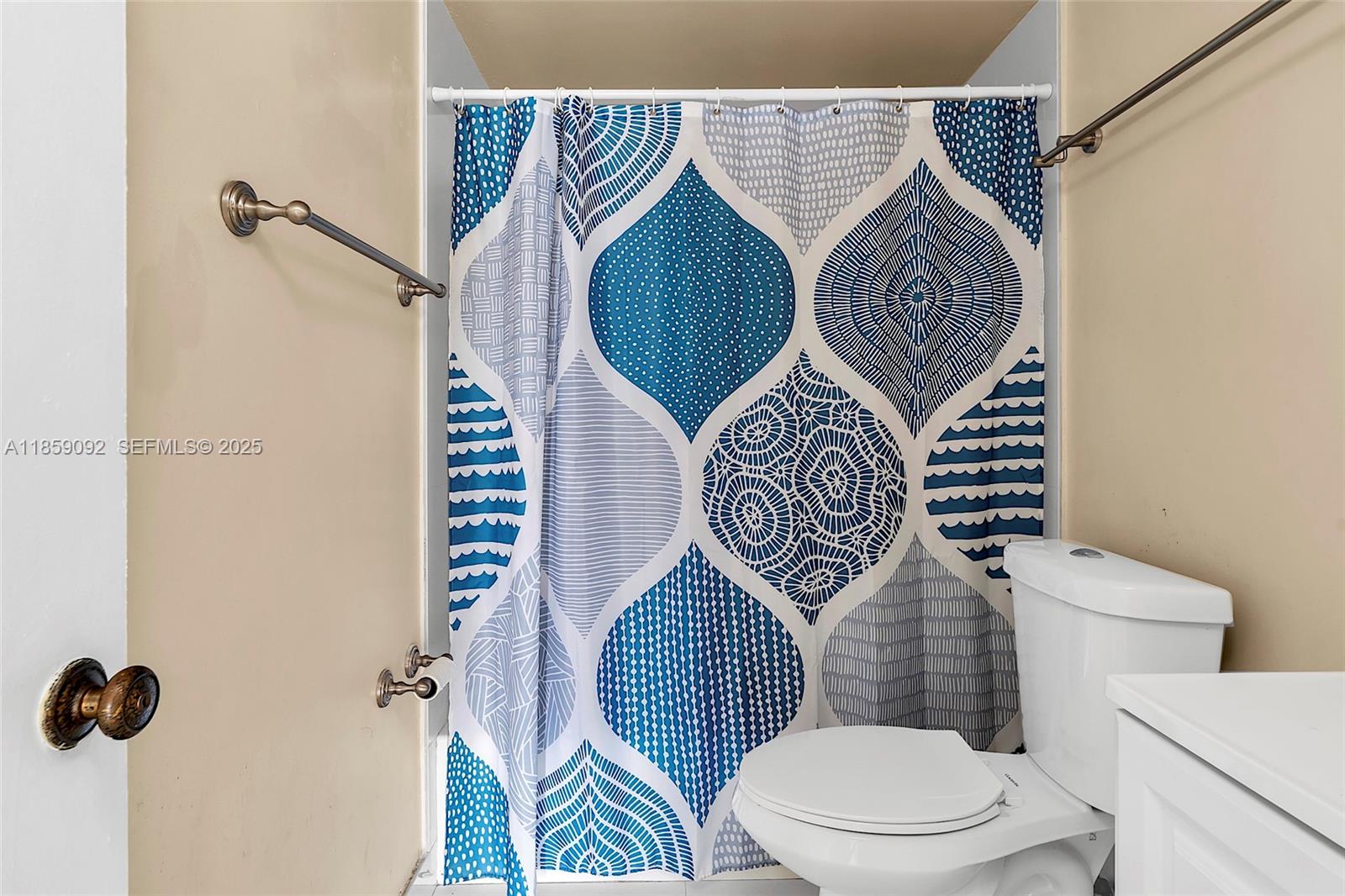 7747 Southwest 86th Street, Unit D106 Miami, FL 33143 - Photo 14 of 19 a bathroom with a toilet and a shower