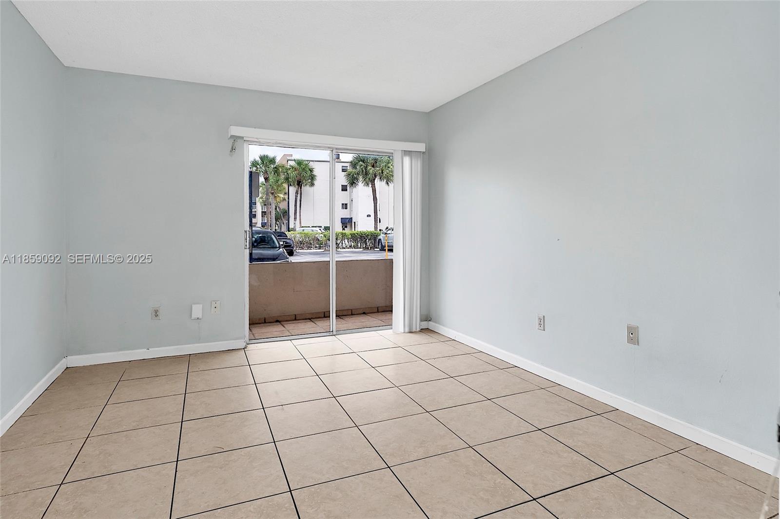 7747 Southwest 86th Street, Unit D106 Miami, FL 33143 - Photo 15 of 19 a view of an empty room and window