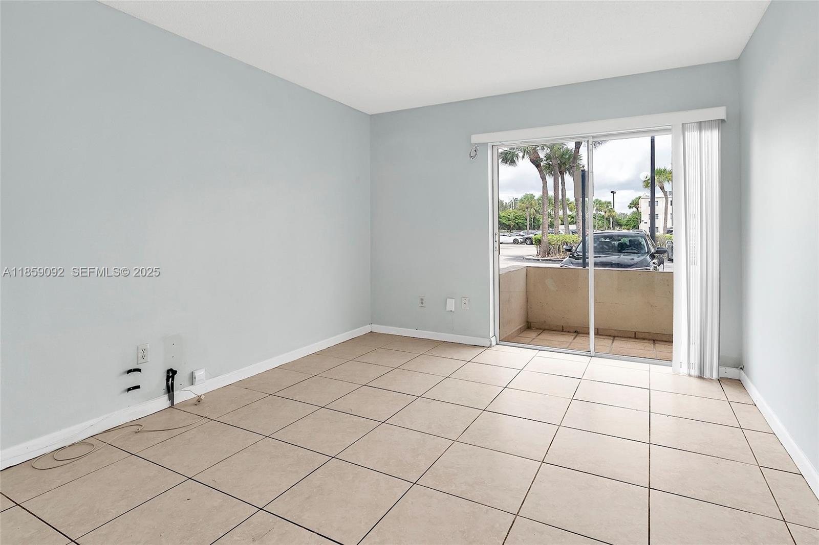 7747 Southwest 86th Street, Unit D106 Miami, FL 33143 - Photo 16 of 19 a view of an empty room and window