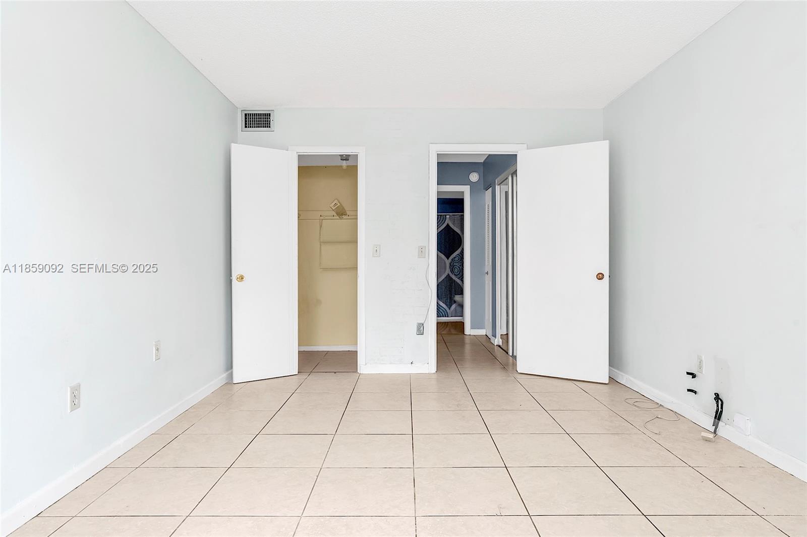 7747 Southwest 86th Street, Unit D106 Miami, FL 33143 - Photo 18 of 19 a view of an empty room with closet