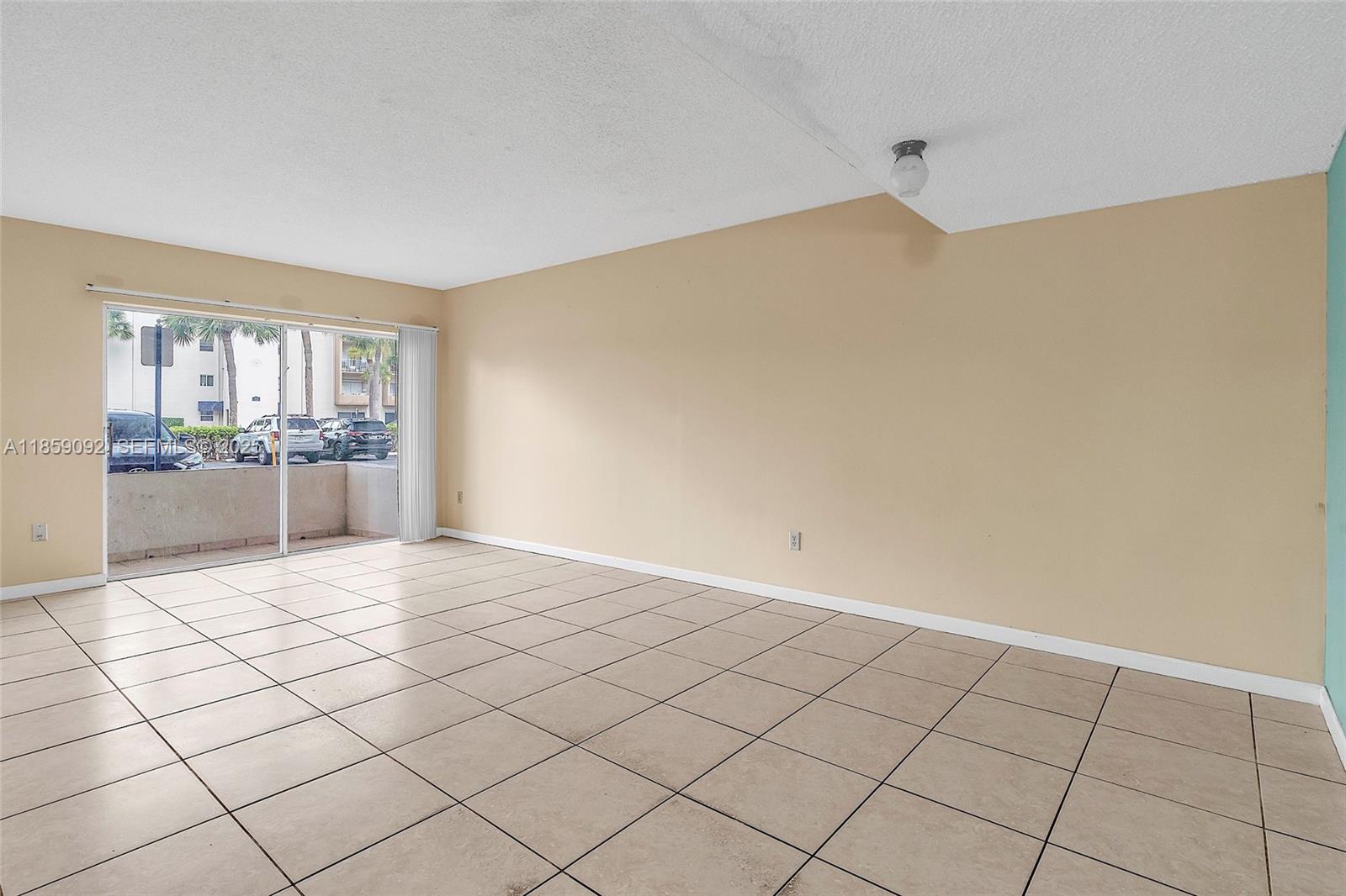 7747 Southwest 86th Street, Unit D106 Miami, FL 33143 - Photo 4 of 19 a view of an empty room and window