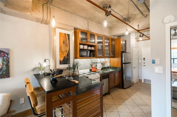 a bathroom with granite countertop shower and a sink