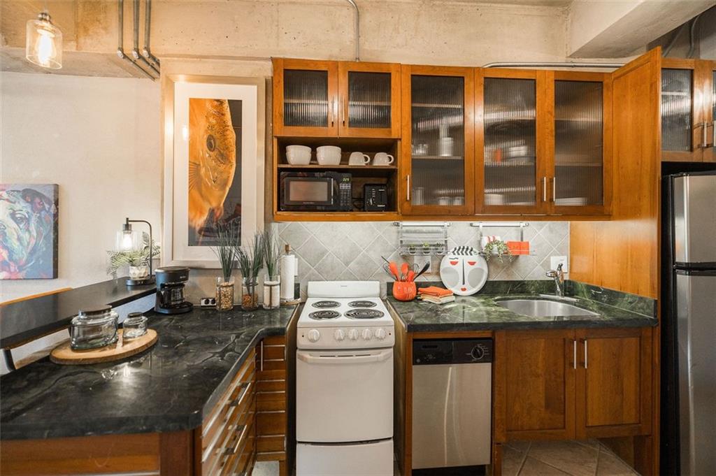 131 East Broad Street, Unit 503 Athens, GA 30601 - Photo 14 of 33 a view of a kitchen with granite countertop a sink and a stove