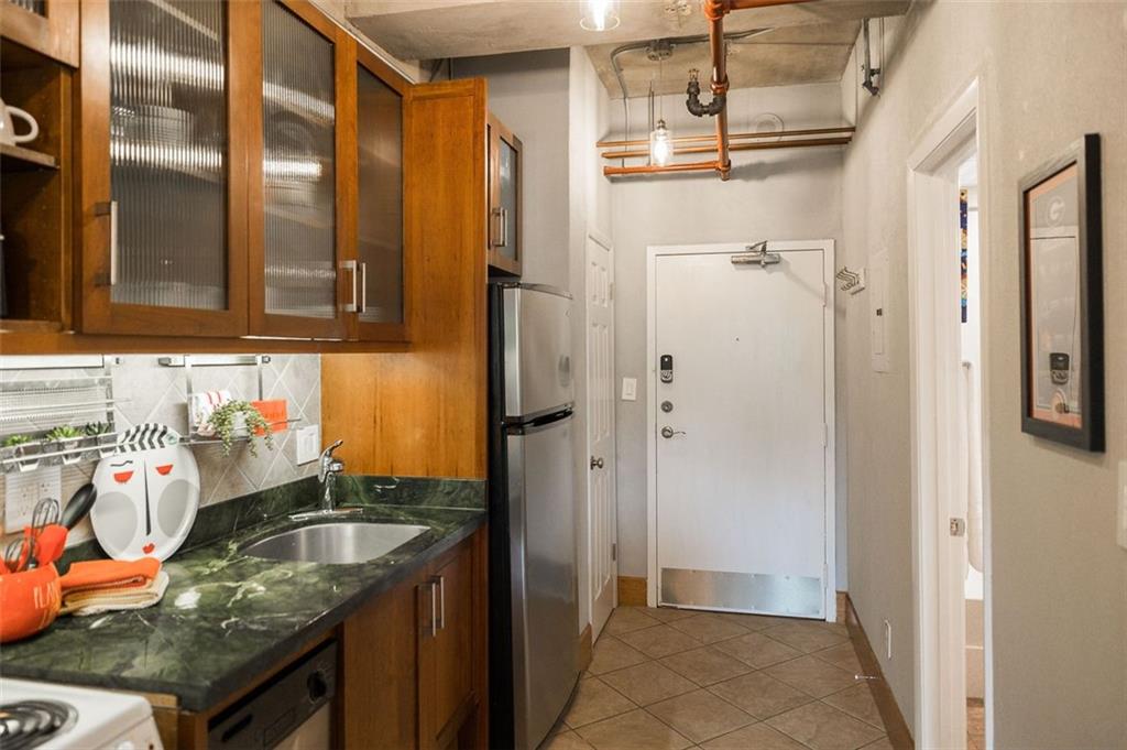131 East Broad Street, Unit 503 Athens, GA 30601 - Photo 15 of 33 a bathroom with granite countertop shower and a sink