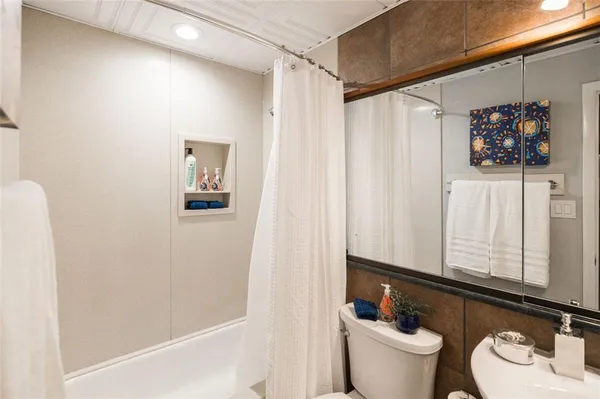 a bathroom with a sink toilet and shower