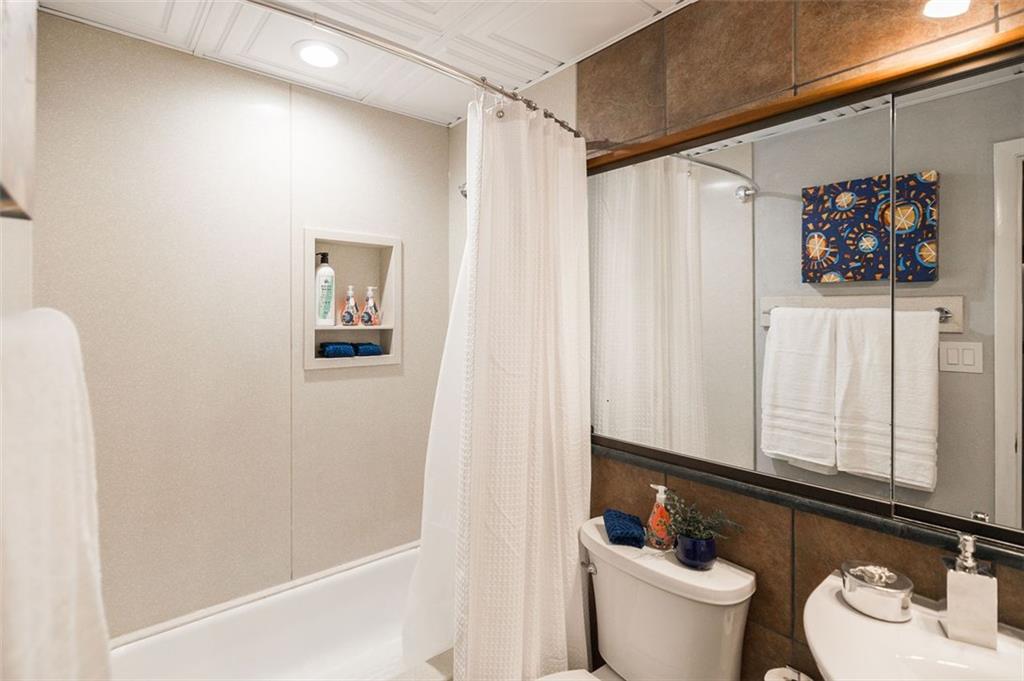 131 East Broad Street, Unit 503 Athens, GA 30601 - Photo 23 of 33 a bathroom with a sink a toilet and shower curtain