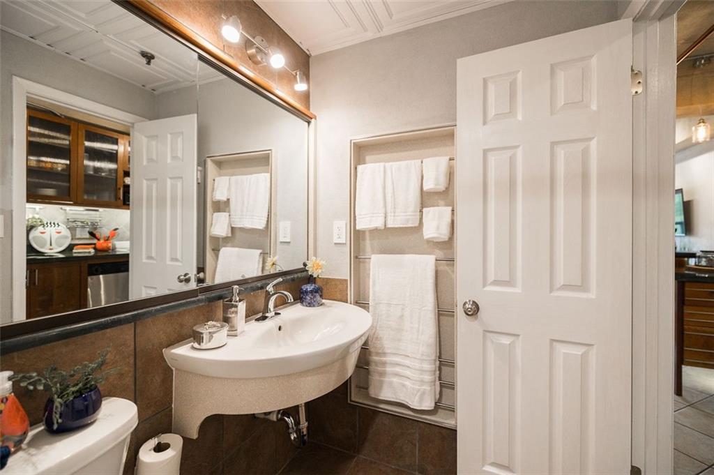 131 East Broad Street, Unit 503 Athens, GA 30601 - Photo 24 of 33 a bathroom with a sink and a mirror