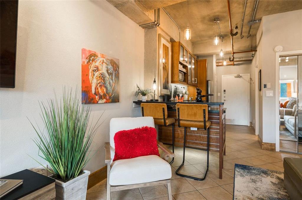 131 East Broad Street, Unit 503 Athens, GA 30601 - Photo 26 of 33 a living room with furniture plant and a window