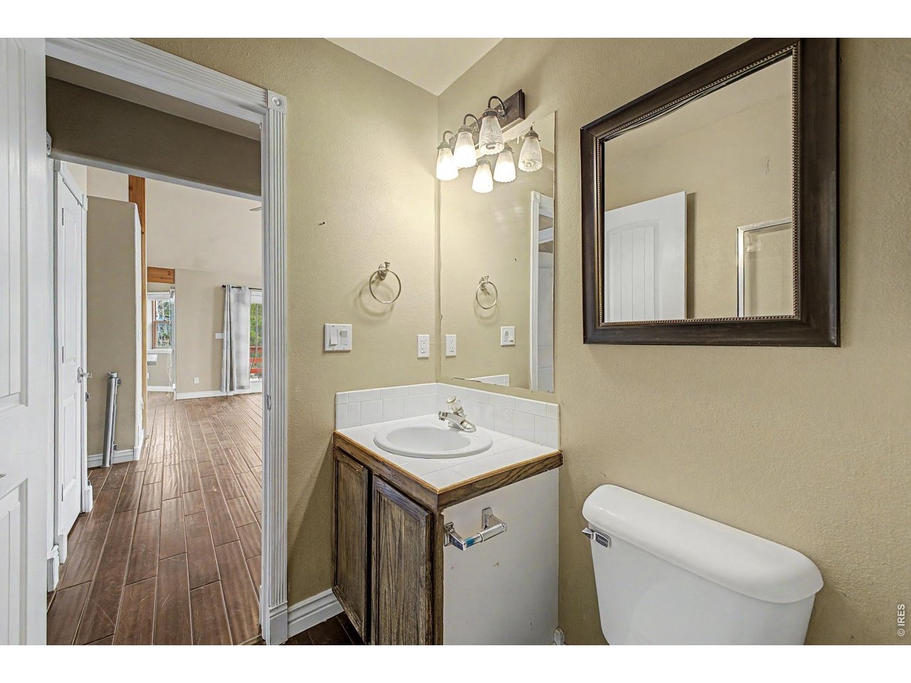 76 Highlands Drive Bailey, CO 80421 - Photo 26 of 49 a bathroom with a sink a mirror and a toilet