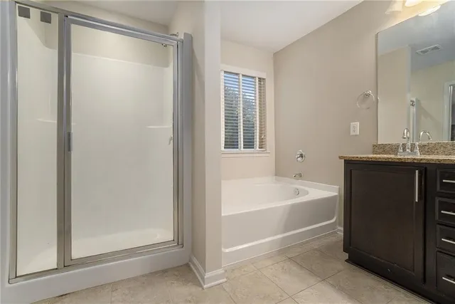 an empty room with windows and ceiling fan