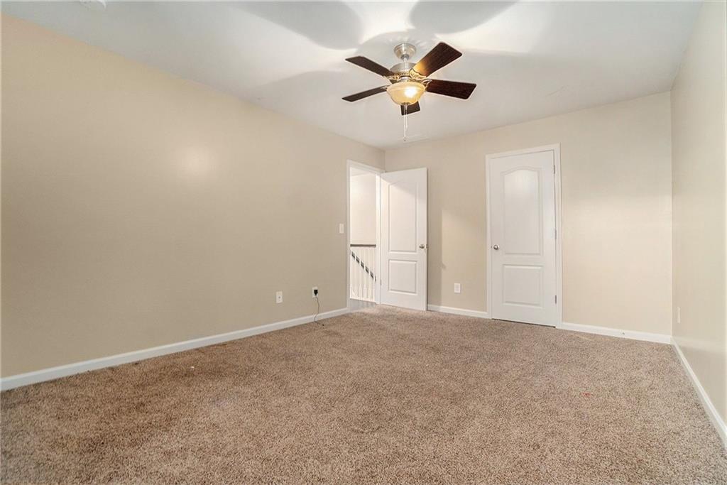 3989 Princeton Lakes Pass Southwest Atlanta, GA 30331 - Photo 18 of 25 an empty room with a window and a fan