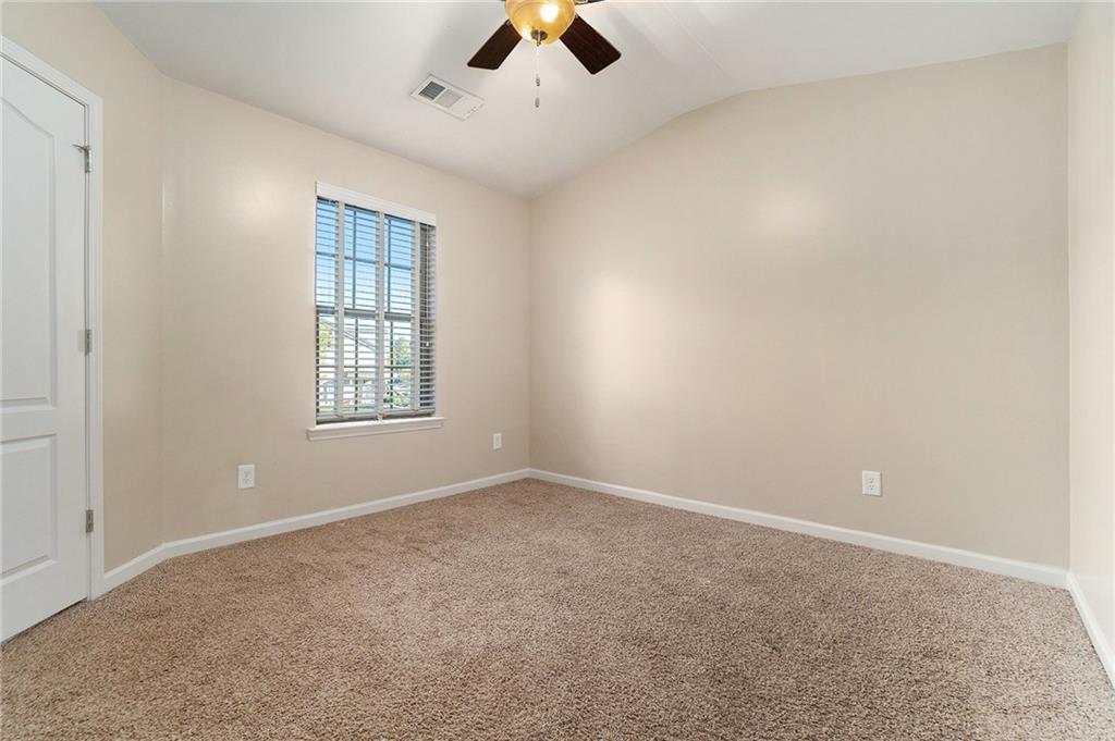 3989 Princeton Lakes Pass Southwest Atlanta, GA 30331 - Photo 19 of 25 an empty room with chandelier fan and windows
