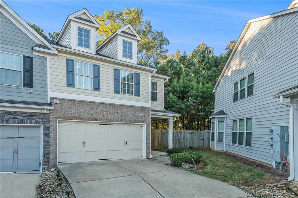 3989 Princeton Lakes Pass Southwest Atlanta, GA 30331 - Photo 2 of 25 a front view of a house with garden