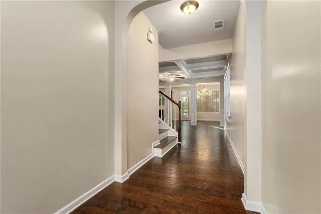 a view of a hallway view with wooden floor and staircase