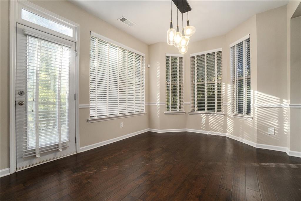 3989 Princeton Lakes Pass Southwest Atlanta, GA 30331 - Photo 8 of 25 a view of an empty room with wooden floor and a window