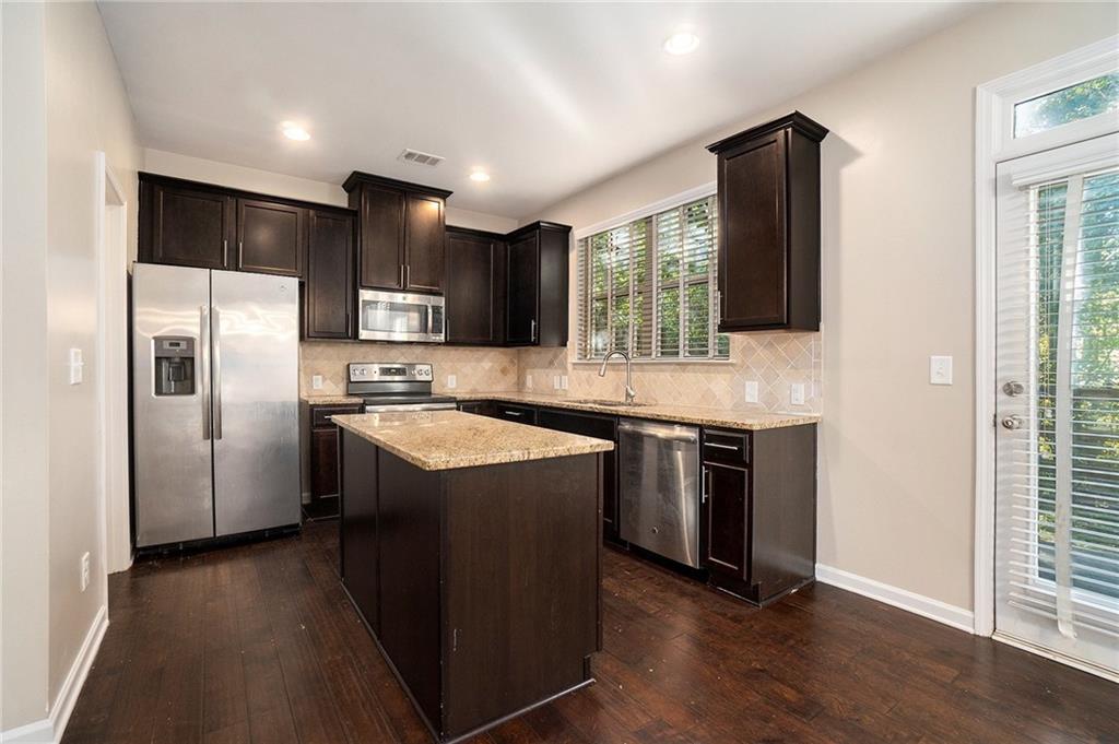 3989 Princeton Lakes Pass Southwest Atlanta, GA 30331 - Photo 9 of 25 a kitchen with stainless steel appliances granite countertop a refrigerator a sink a stove and oven