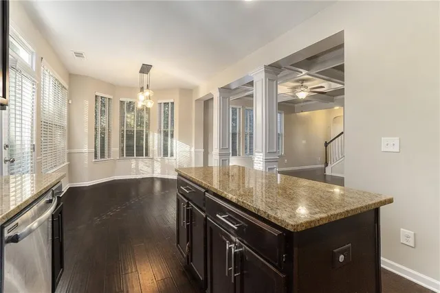 a kitchen with granite countertop a sink and cabinets