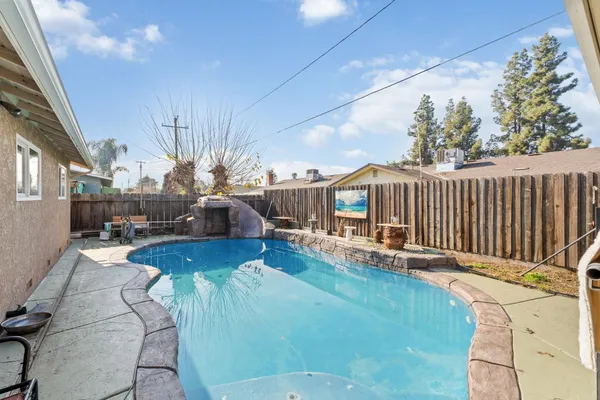 a living room with furniture floor to ceiling window and wooden floor