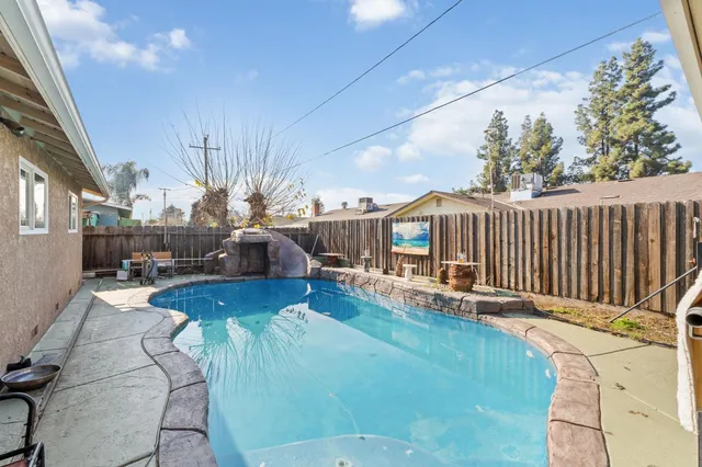 a living room with furniture floor to ceiling window and wooden floor