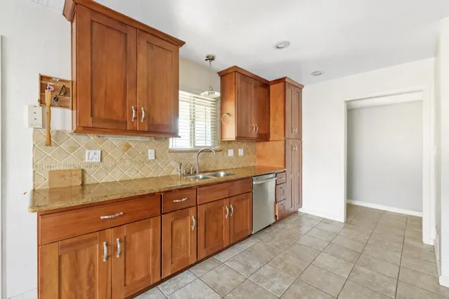 a spacious bathroom with a granite countertop sink a mirror and a