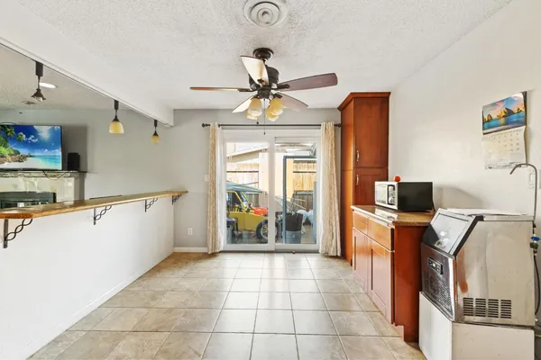 a kitchen with stainless steel appliances a counter top space appliances and a chandelier