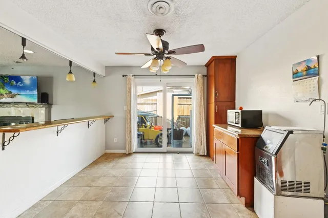a kitchen with stainless steel appliances a counter top space appliances and a chandelier