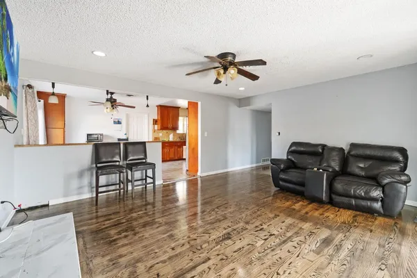 a living room with furniture and wooden floor