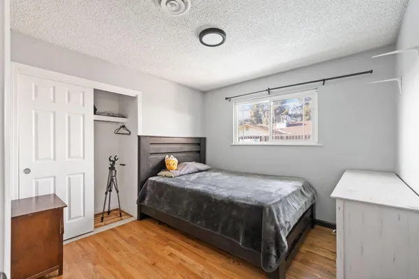 a bedroom with a bed and a painting on the wall