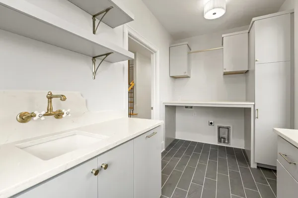 a bathroom with a granite countertop sink a toilet a mirror a bathtub and shower