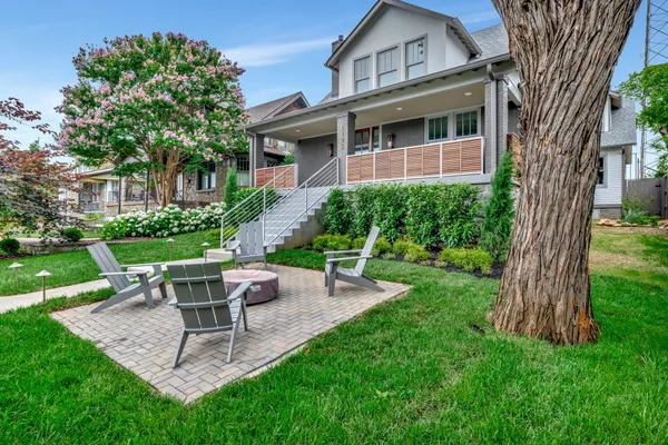 a view of a house with a yard and sitting area