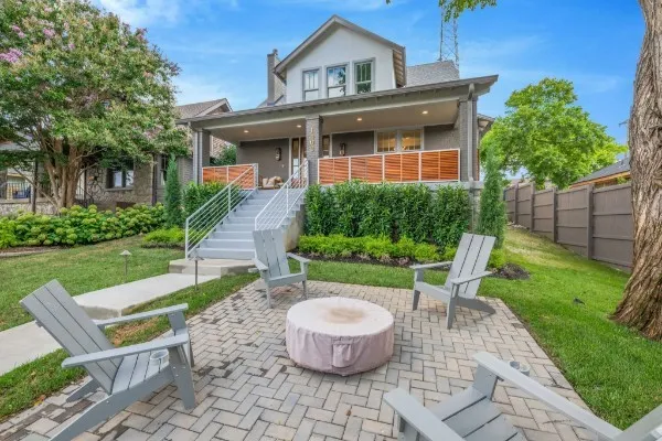a living room with furniture a fireplace and a potted plant