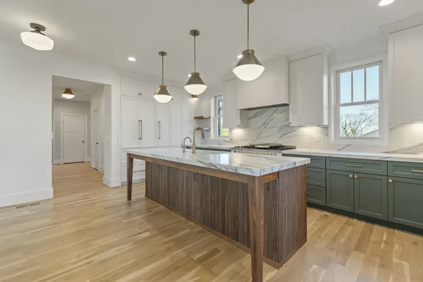 a kitchen with a sink appliances and cabinets
