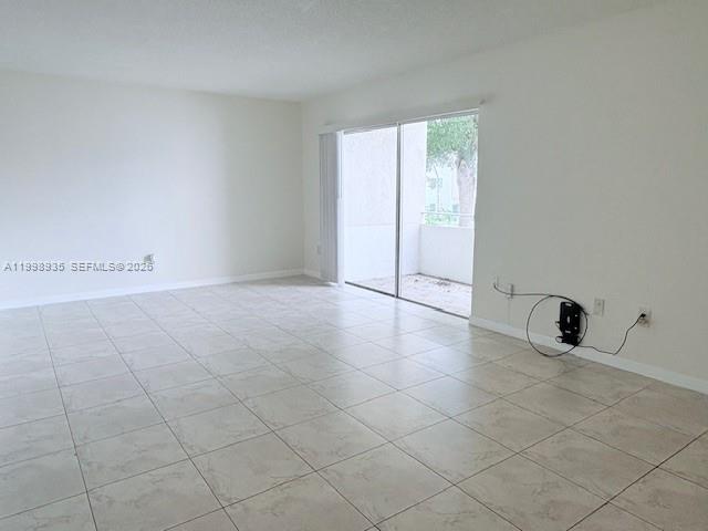 7785 Southwest 86th Street, Unit E219 Miami, FL 33143 - Photo 2 of 9 a view of an empty room with a window