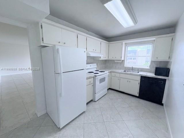 7785 Southwest 86th Street, Unit E219 Miami, FL 33143 - Photo 5 of 9 a kitchen with a refrigerator sink and cabinets