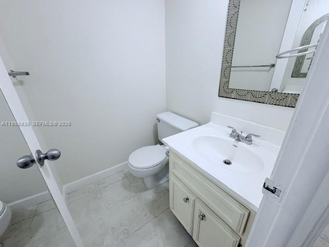 7785 Southwest 86th Street, Unit E219 Miami, FL 33143 - Photo 9 of 9 a bathroom with a sink and mirror with toilet