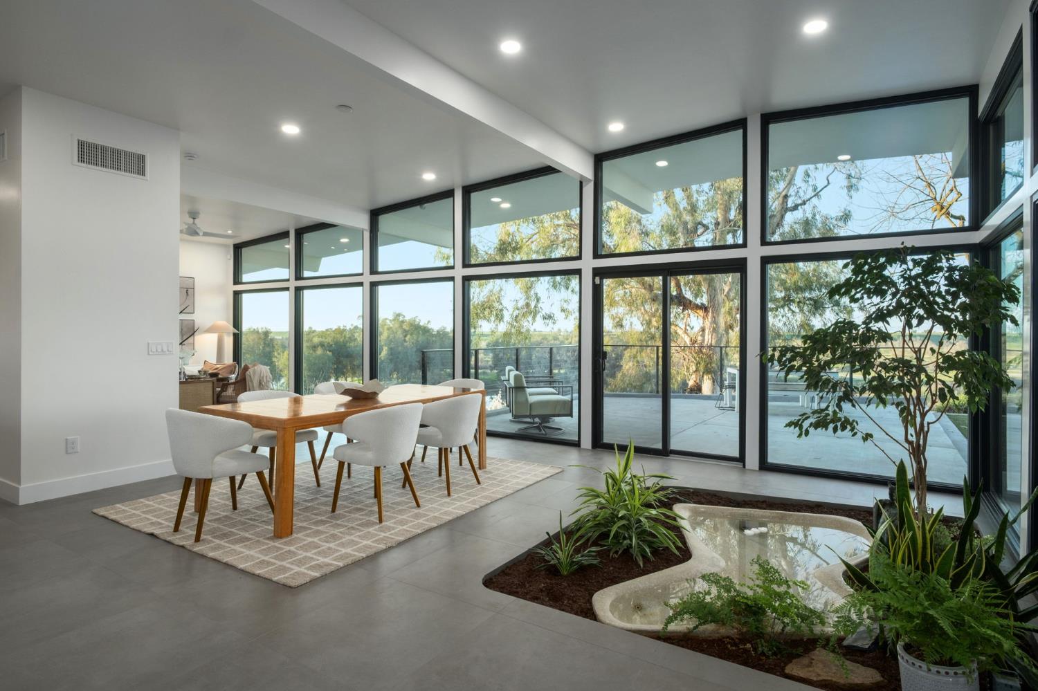 1230 West Moraga Road Fresno, CA 93711 - Photo 14 of 66 a view of a dining room with furniture large windows and wooden floor