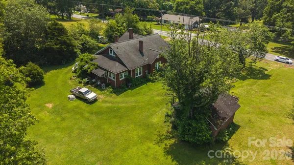 a aerial view of a house with a yard basket ball court and outdoor seating