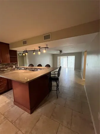 a kitchen with stainless steel appliances granite countertop a sink and cabinets