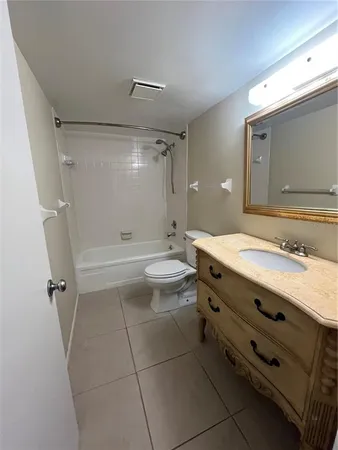 a bathroom with a double vanity sink toilet mirror and shower